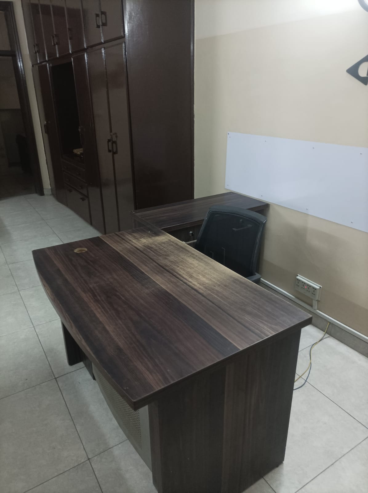 Executive desk with walnut wood cabinetry in a private office at KAMH Lahore