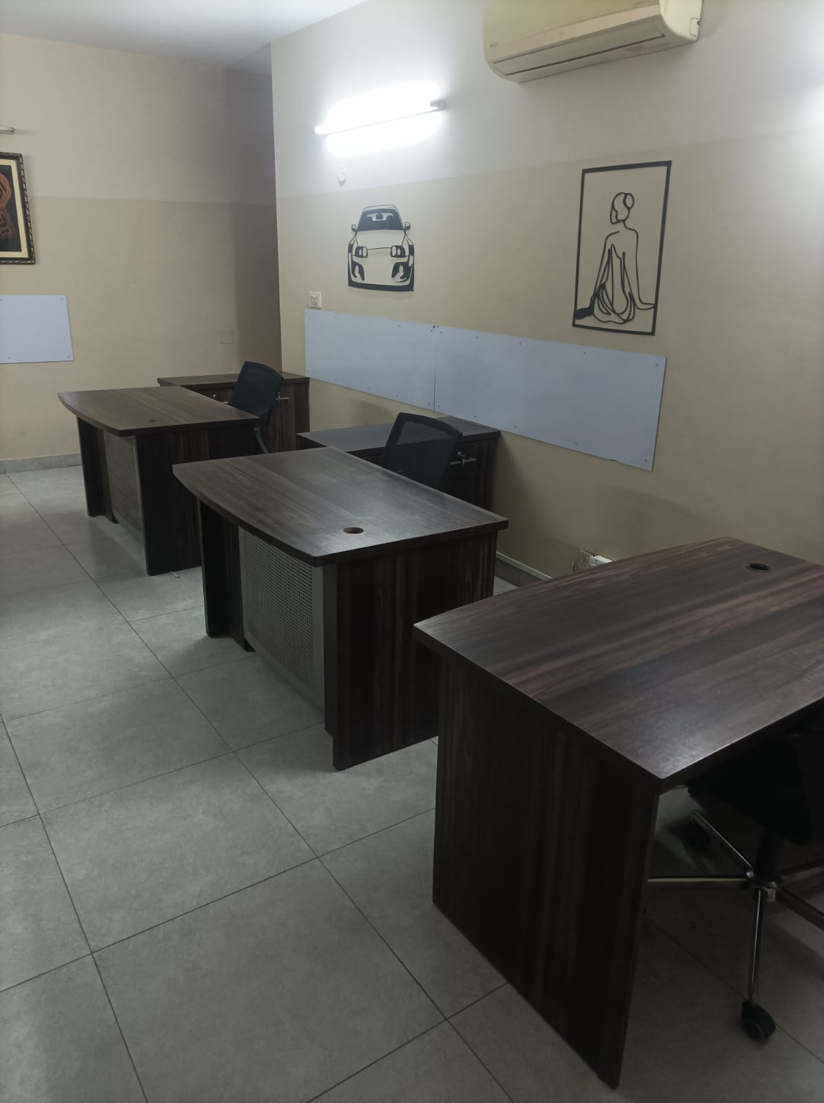 Private 4-person team studio with dark wood desks at KAMH Lahore