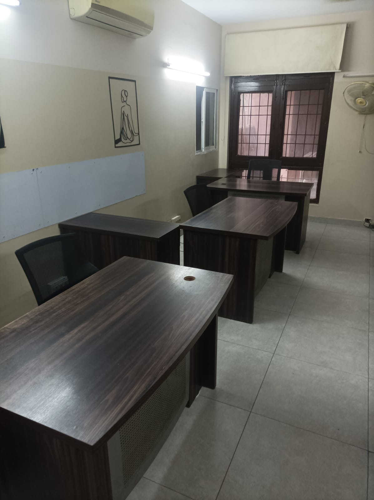 Enclosed team office with dark wood window frame at KAMH coworking Lahore
